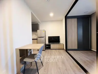 Modern studio apartment with sleek kitchen and cozy living area, perfect for urban living.