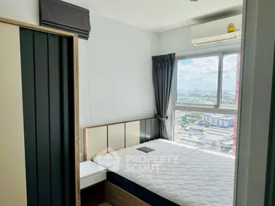 Modern bedroom with city view, featuring a comfortable bed and air conditioning, perfect for urban living.