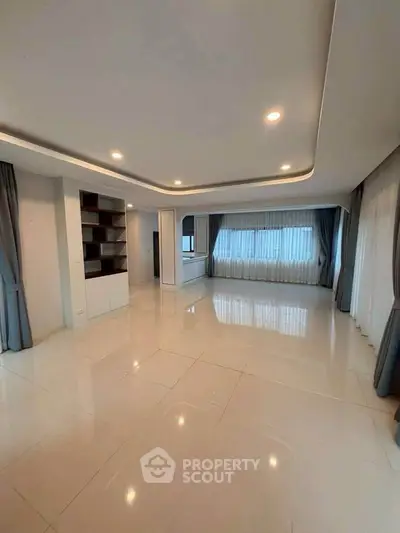 Spacious modern living room with elegant lighting and large windows