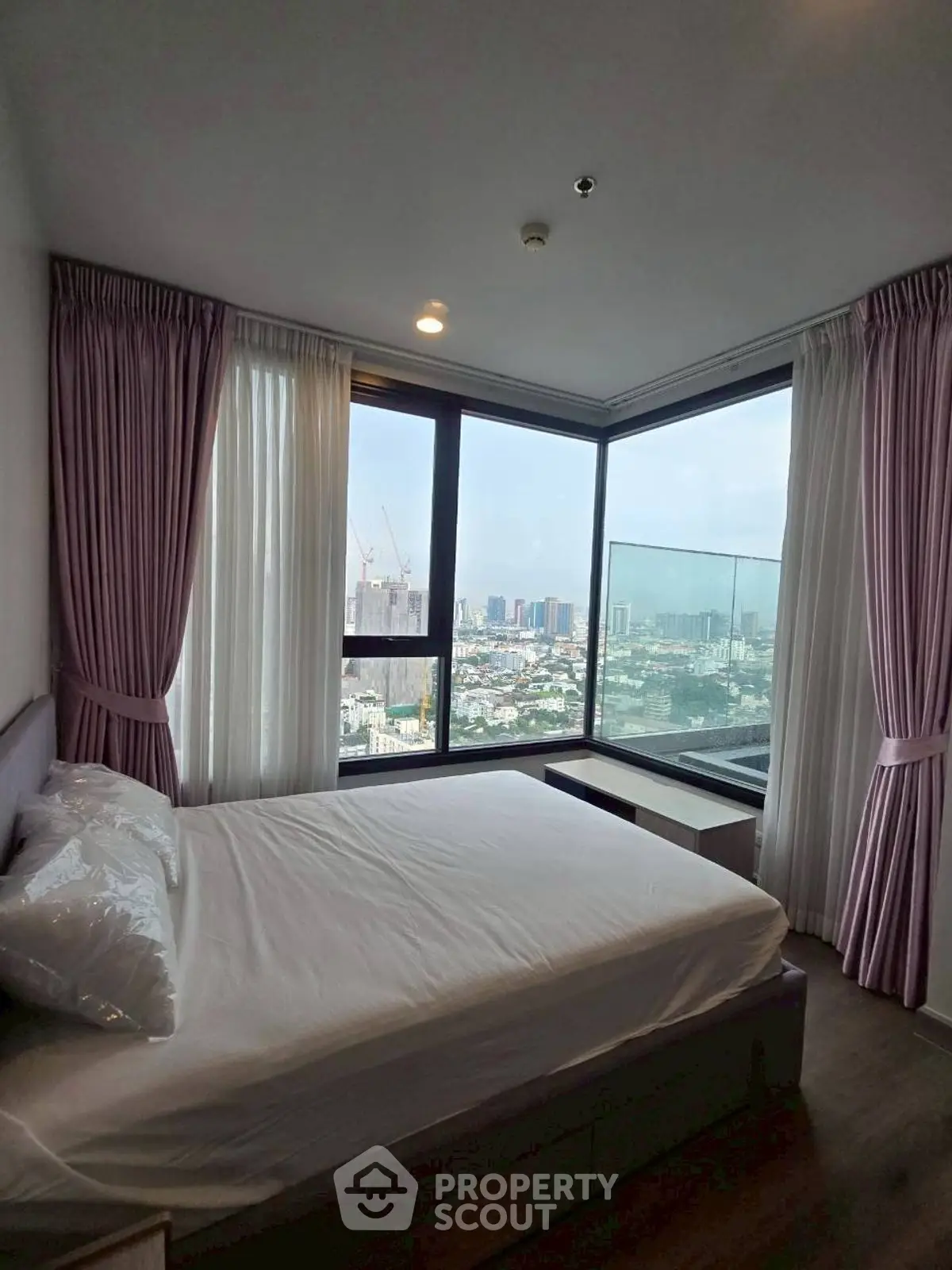 Luxurious bedroom with panoramic city view and elegant decor