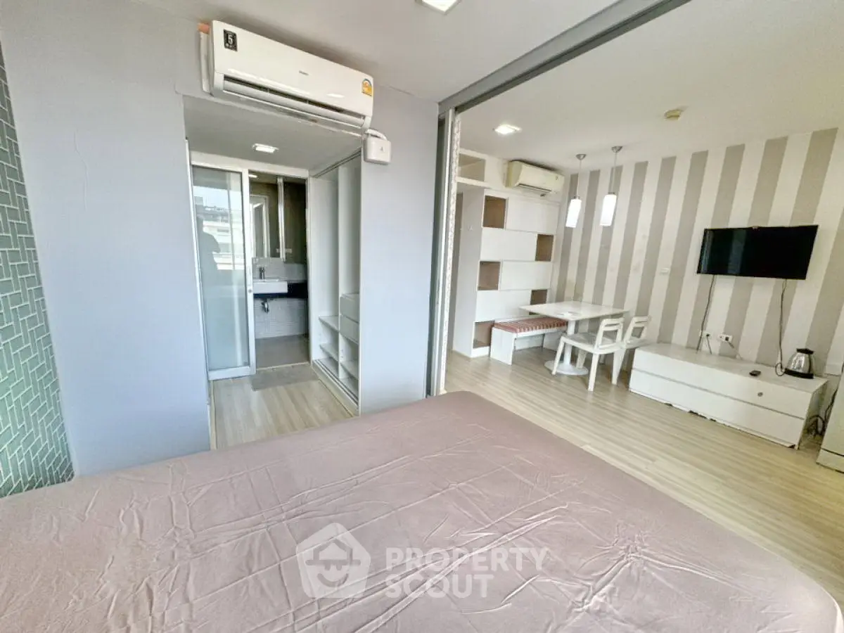 Modern studio apartment with open layout, featuring a cozy living area and stylish decor.