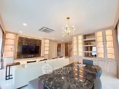Luxurious living room with elegant chandelier and marble dining table