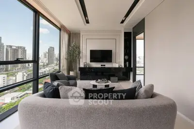 Luxurious modern living room with panoramic city views and elegant decor.