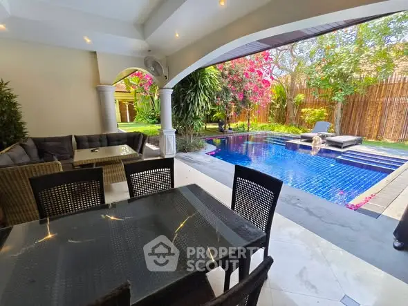 Luxurious outdoor patio with pool and garden, perfect for relaxation and entertainment.