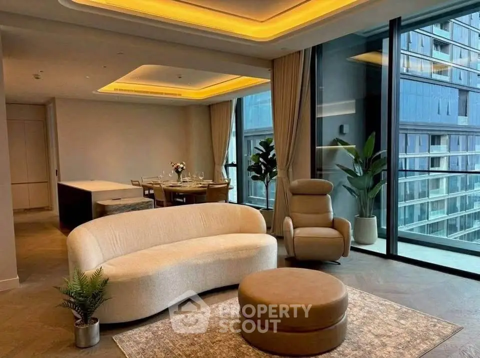 Luxurious modern living room with elegant furniture and floor-to-ceiling windows offering stunning city views.