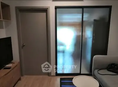 Modern living room with frosted glass sliding doors and cozy seating area.