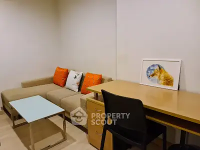 Cozy living room with modern sofa, stylish desk, and vibrant decor accents.
