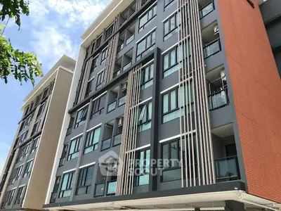 Modern apartment building exterior with sleek design and large windows