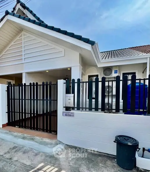 Charming single-story home with modern fence and clean exterior design.