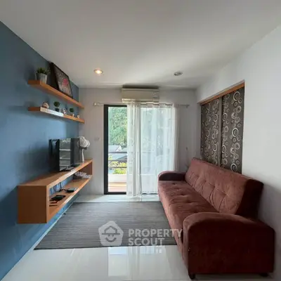 Modern living room with stylish decor and balcony view, featuring a cozy sofa and wall-mounted TV.