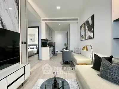 Modern open-plan living room with stylish decor and a glimpse of the bedroom, perfect for urban living.