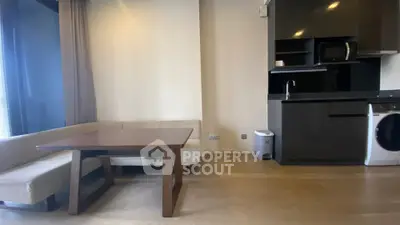 Modern living room with sleek kitchen and cozy dining area