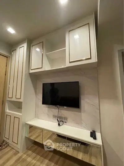 Modern living room with built-in TV unit and elegant cabinetry