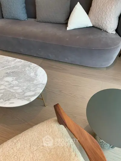 Stylish modern living room with elegant sofa and marble coffee table, perfect for urban living.