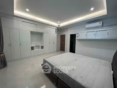 Spacious bedroom with modern built-in wardrobes and air conditioning