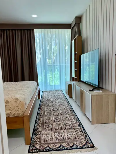 Stylish bedroom with modern decor and large window view