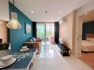 Modern living room with stylish decor and balcony view in urban apartment.