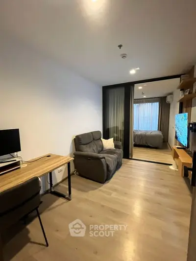 Modern studio apartment with cozy living area and workspace