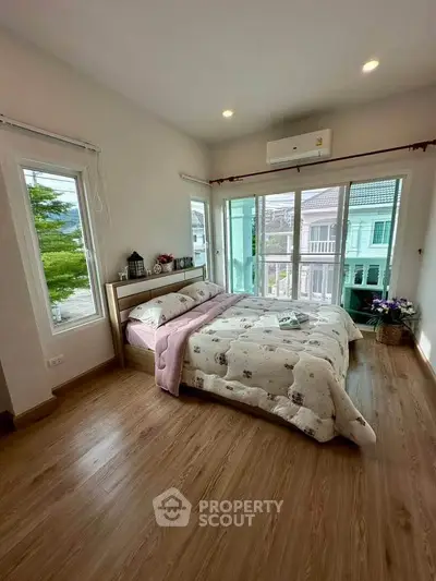 Bright and airy bedroom with large windows and modern decor