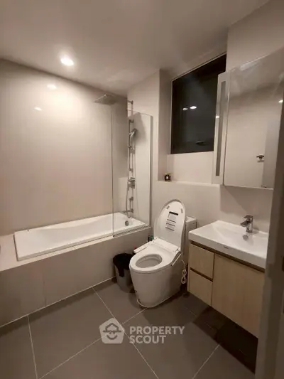 Modern bathroom with sleek fixtures and a bathtub in a contemporary apartment.
