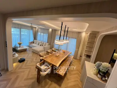Luxurious open-plan living and dining area with elegant wooden flooring and modern decor.