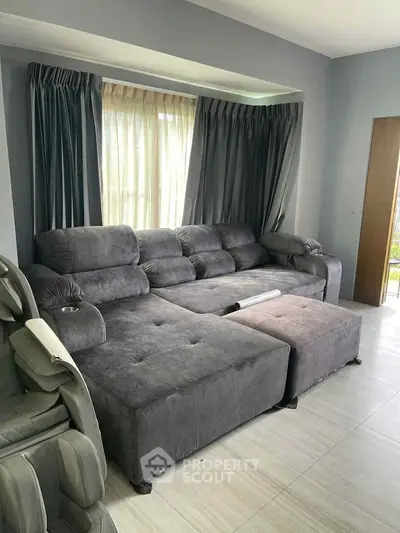 Spacious living room with plush gray sectional sofa and modern decor