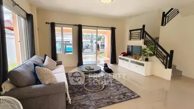 Spacious living room with modern decor and large windows in a stylish home