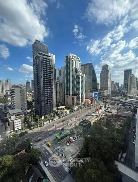 Stunning cityscape view of modern high-rise buildings under a vibrant blue sky.