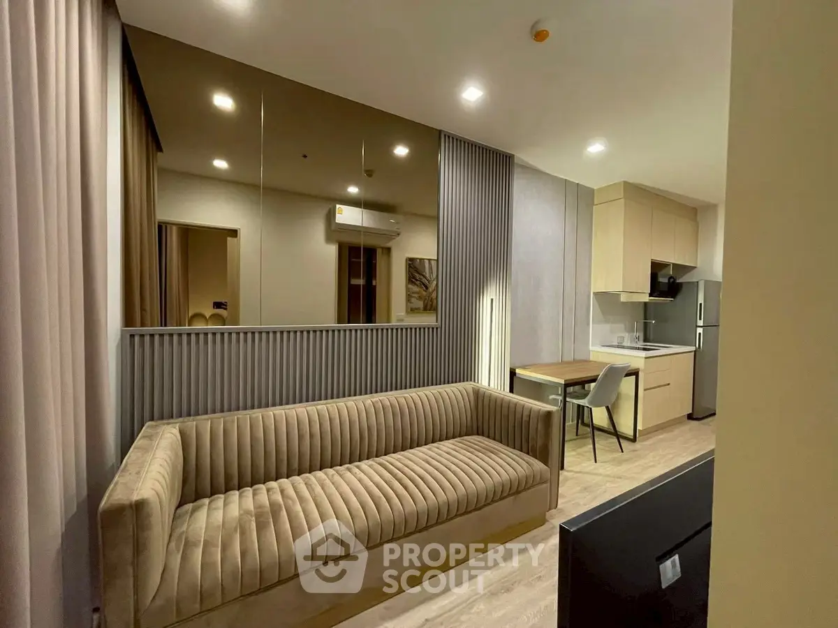 Modern living room with stylish sofa and open kitchen layout