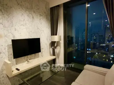 Modern living room with city view, marble accent wall, and sleek furnishings.