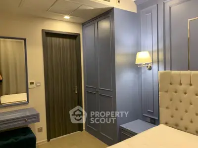 Elegant bedroom with stylish blue paneling and modern lighting