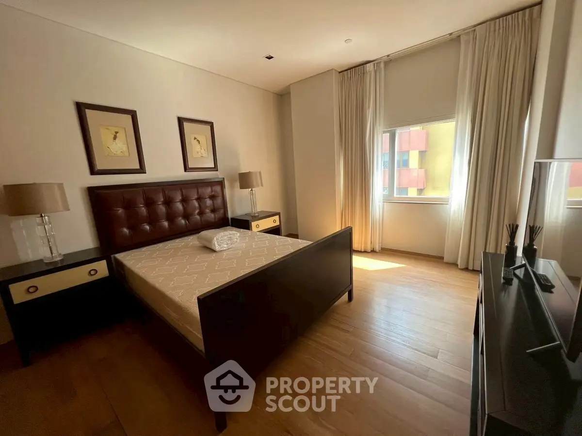 Spacious bedroom with elegant decor and natural light