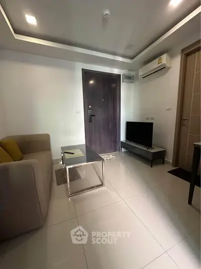 Modern living room with sleek furniture and air conditioning in a contemporary apartment.