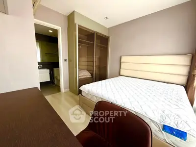 Modern bedroom with ensuite bathroom and stylish furniture in a contemporary apartment.