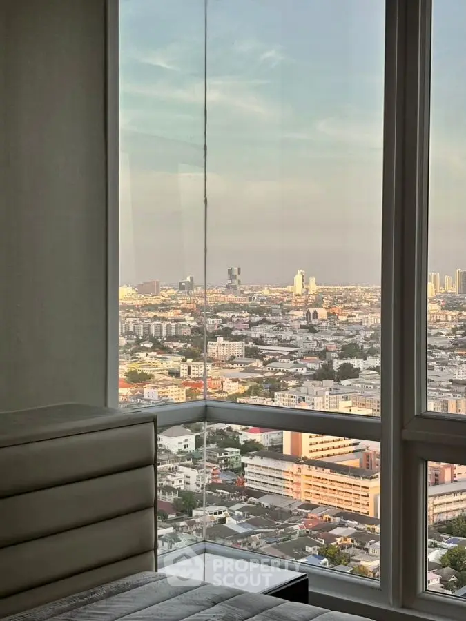 Stunning city view from a high-rise apartment window, showcasing urban landscape and skyline.