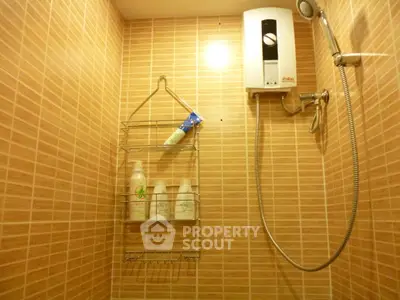 Modern bathroom with tiled walls and electric shower heater