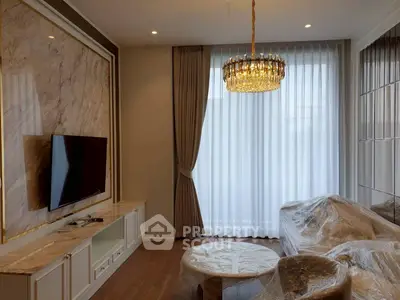 Luxurious living room with elegant chandelier and modern TV setup