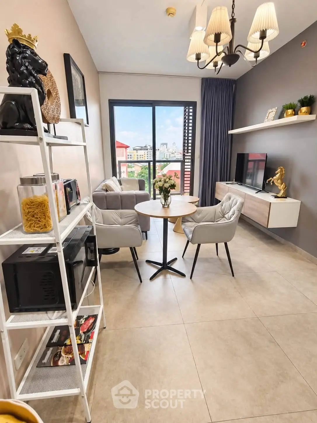 Modern living room with elegant decor and balcony view, featuring stylish furniture and natural light.