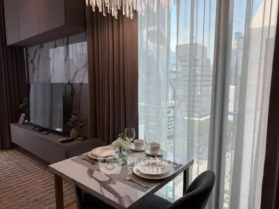 Luxurious dining area with elegant marble table and stunning city view through floor-to-ceiling windows.