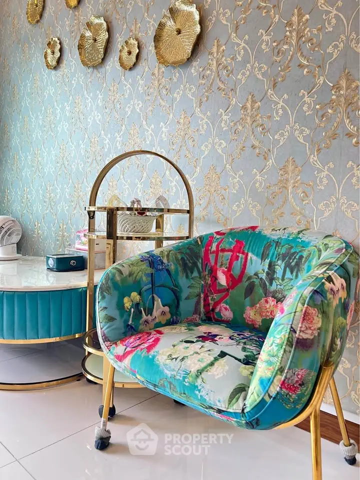 Luxurious living room with floral armchair and elegant gold accents
