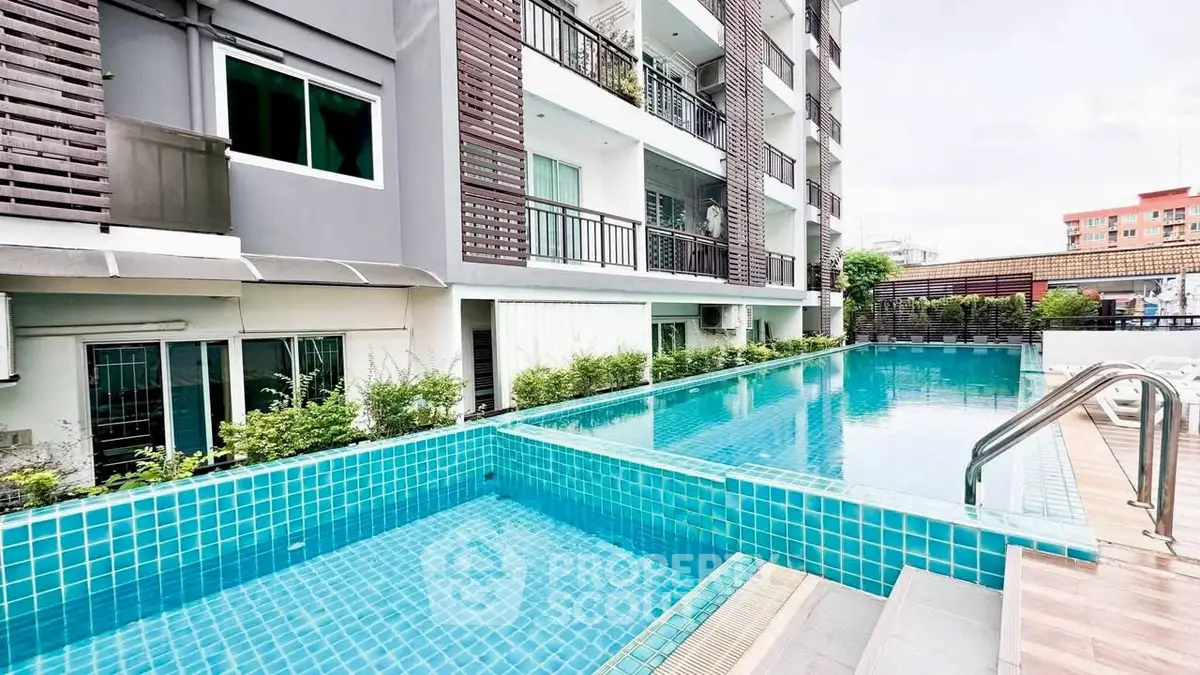 Modern apartment building with a stunning outdoor pool and sleek design.