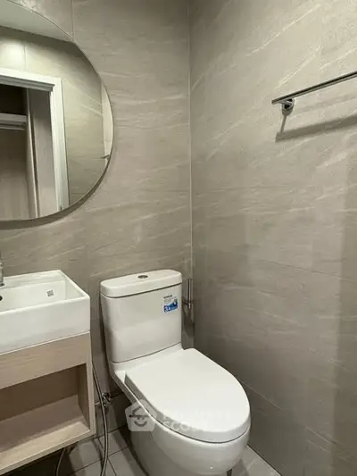 Modern bathroom with sleek design and round mirror