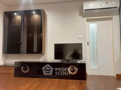 Modern living room with sleek TV stand and air conditioning unit, perfect for cozy entertainment.