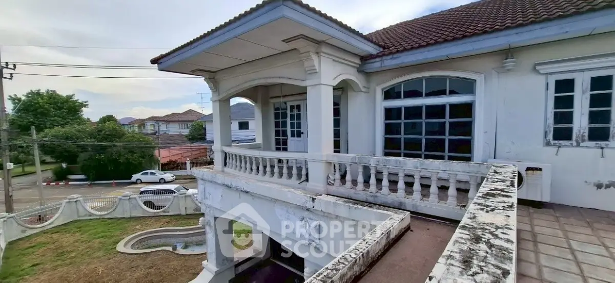 Charming two-story house with spacious balcony and classic architectural details.