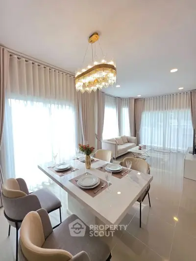 Luxurious modern living room with elegant dining area and stunning chandelier
