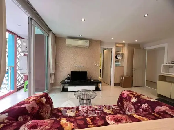 Stylish living room with floral sofa and modern decor in a bright apartment