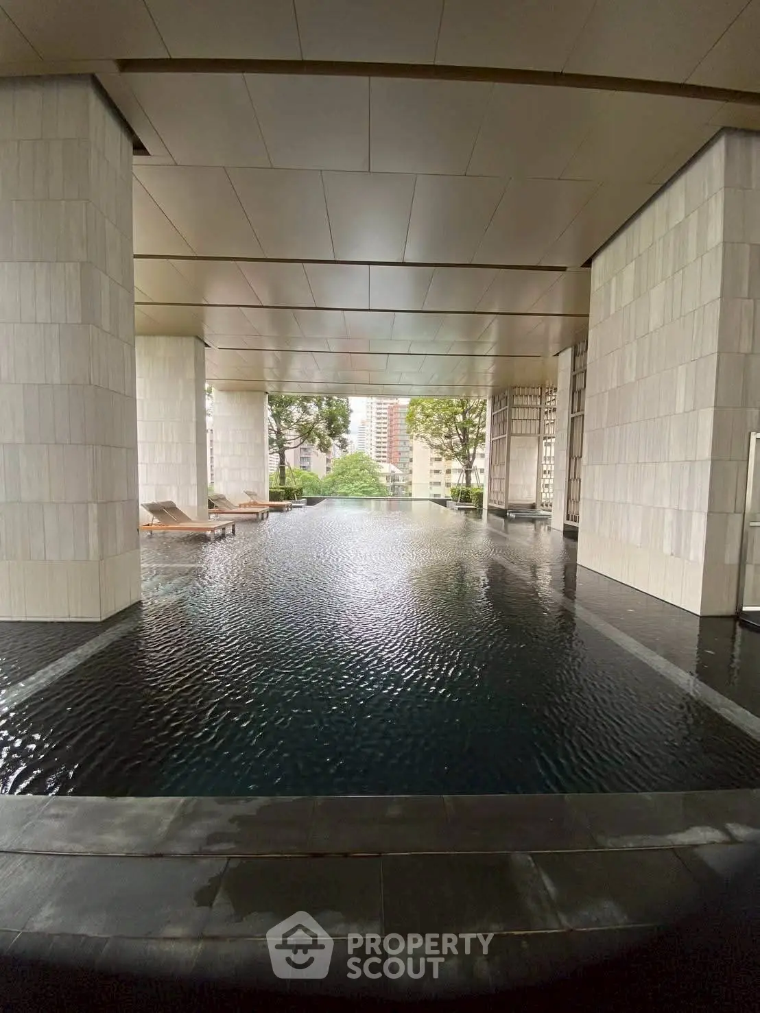 Luxurious infinity pool with city view in modern high-rise building