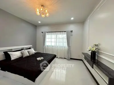 Spacious modern bedroom with elegant decor and natural light