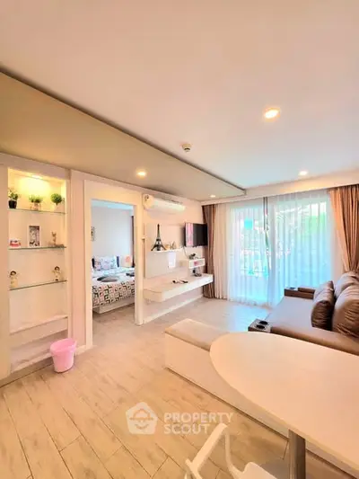 Spacious living room with modern decor and large windows offering natural light.