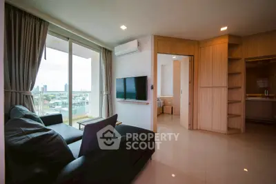 Modern living room with city view, sleek furniture, and natural light